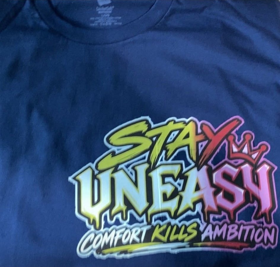 Stay Uneasy — Comfort Kills Ambition graphic tee